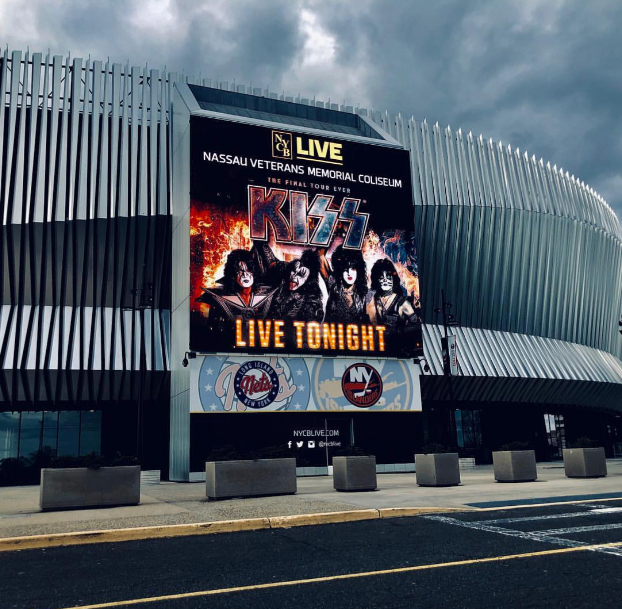 Large exterior digital marquee at Nassau Veterans Memorial Coliseum showing a concert graphic