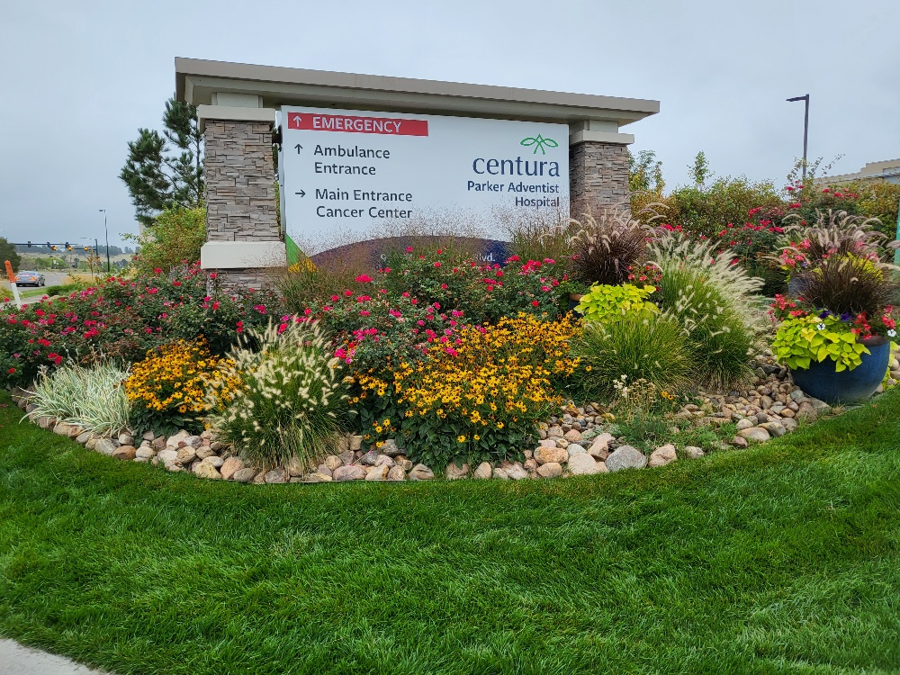 Centura Parker Adventist Hospital ground-level monument sign with directional wayfinding and landscaped garden