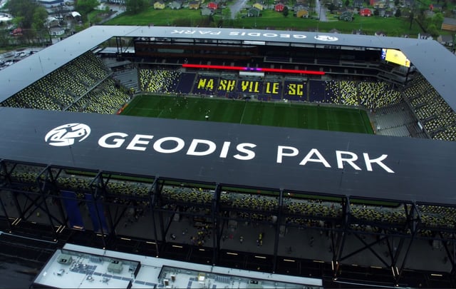 Aerial view of GEODIS Park with large white GEODIS PARK letters along the stadium roof edge
