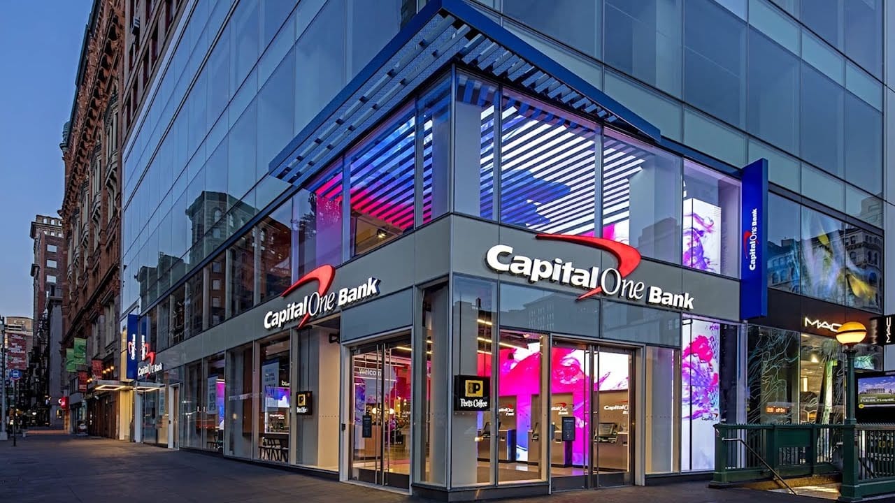 Capital One Bank corner branch with illuminated channel letters and integrated digital branding at dusk